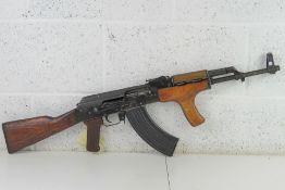 A deactivated Romanian AKM Assault Rifle