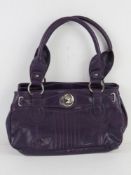 A purple leather handbag by Clarks, appr