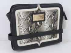 A clutch bag by Lipsy in black with 'pyt