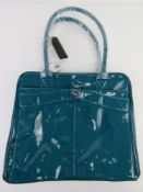 A teal patent overnight bag by Storm Lon