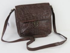 A brown leather faux crocodile skin hand