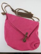 A hot pink canvas and suede cross body b