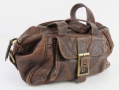 A brown leather handbag by Smith & Conov