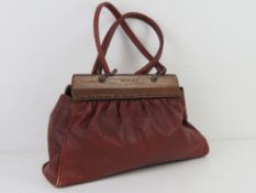 Radley; a red leather handbag with woode