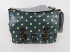A green polka dot satchel type handbag '