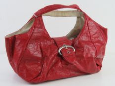 A red patent handbag by River Island app