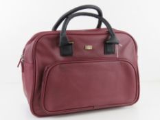 A burgundy coloured overnight bag by Sto