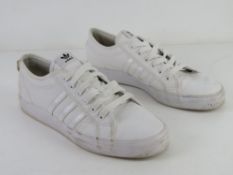 A pair of size 11 men's white trainers.