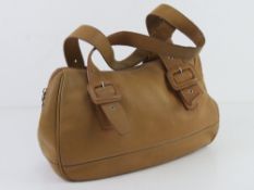 Lacoste; a sand coloured leather handbag