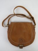 A tan leather cross body handbag by clar