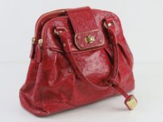 Jasper Conran; a red leather handbag hav