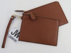A pair of Jason Wu brown zip-top wallets