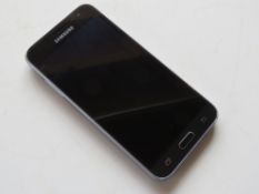 A Samsung Galaxy J320 mobile phone in bl