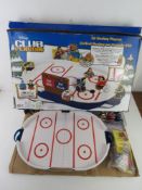 A Disney Club penguin air hockey playset.