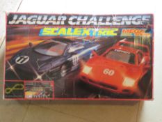 A Scalextric Jaguar Challenge in play worn condition with two original cars and two additional cars.