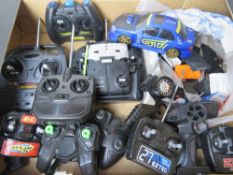 A RC Subaru Impreza together with a quantity of assorted RC vehicles and controllers.