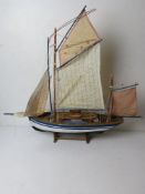 A model sailing boat having life boats and rigging measuring approx 70cm in length.