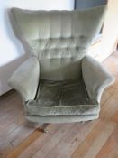 A green velour armchair.