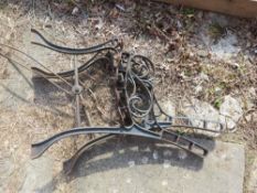 A pair of metal bench ends, support strap a/f.