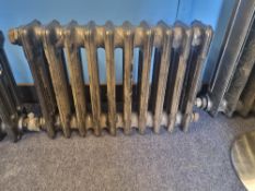 A refurbished cast iron Victorian column radiator having ten fins and measuring 63cm wide,