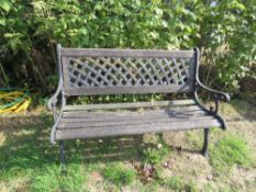 A garden bench for refurbishment having metal ends and back.
