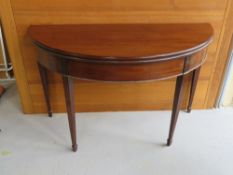 A foldover oval occasional table with tapering square shaped legs,