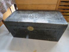 A black painted carved pine blanket box, measuring approx 101 x 50 x 47cm.