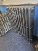 A refurbished cast iron Victorian column radiator having eleven fins and integral feet and