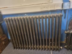 A refurbished cast iron Victorian column radiator having eighteen fins and measuring 107cm wide,