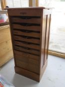 A tambour fronted music cabinet having nine drawers within, no key.