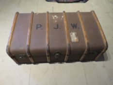 A canvas covered trunk opening to reveal lined compartment and tray within,