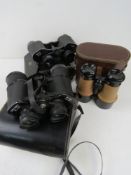 Thre binoculars all in cases, being Weig