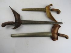 Three antique Kris knives with scabbards