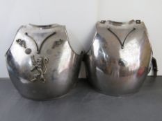 Two chest armours with leather straps.