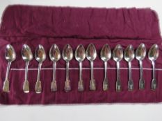 A set of twelve HM silver spoons in roll, hallmarked London 1824 and bearing maker's mark 'JH'.