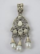 A silver pearl and mother of pearl pendant, stamped 925 and measuring 6.1cm in length.