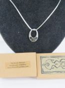 A Native American sterling silver pendant inlaid with onyx and bearing designer's mark Teme on