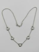 A silver five heart necklace, stamped 925, adjustable length 43 - 45cm.