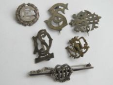 A HM silver monogram brooch, together with two silver monogram brooches,