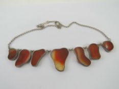 A silver carnelian and chalcedony banded agate seven panel necklace, stamped 925,