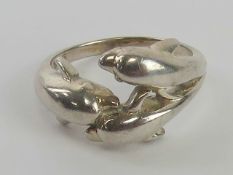 A silver ring in the form of three leaping dolphins, stamped 925, size L.