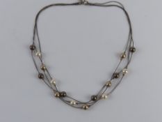A silver and faux pearl necklace by Magnolia, stamped 925 with designer's label upon,