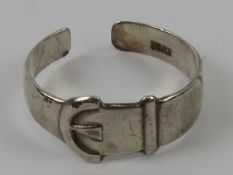 A silver ring in the form of a belt and buckle, stamped silver, slightly adjustable size approx S.