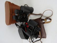 Three pairs of Binoculars, all in cases,