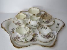 A 19thC tea set comprising three cups, four saucers, jug, sugar bowl and tray,
