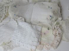 A quantity of assorted lace and linen inc table cloths, placemats, etc.