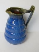 A Denby ware blue and green glazed jug standing 18.5cm high.