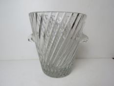 A large cut glass champagne ice bucket having twin handles.
