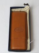 A Don Tomas leather cigar holder in presentation box.