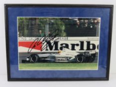 A hand signed photograph of Ralf Schumacher, framed.